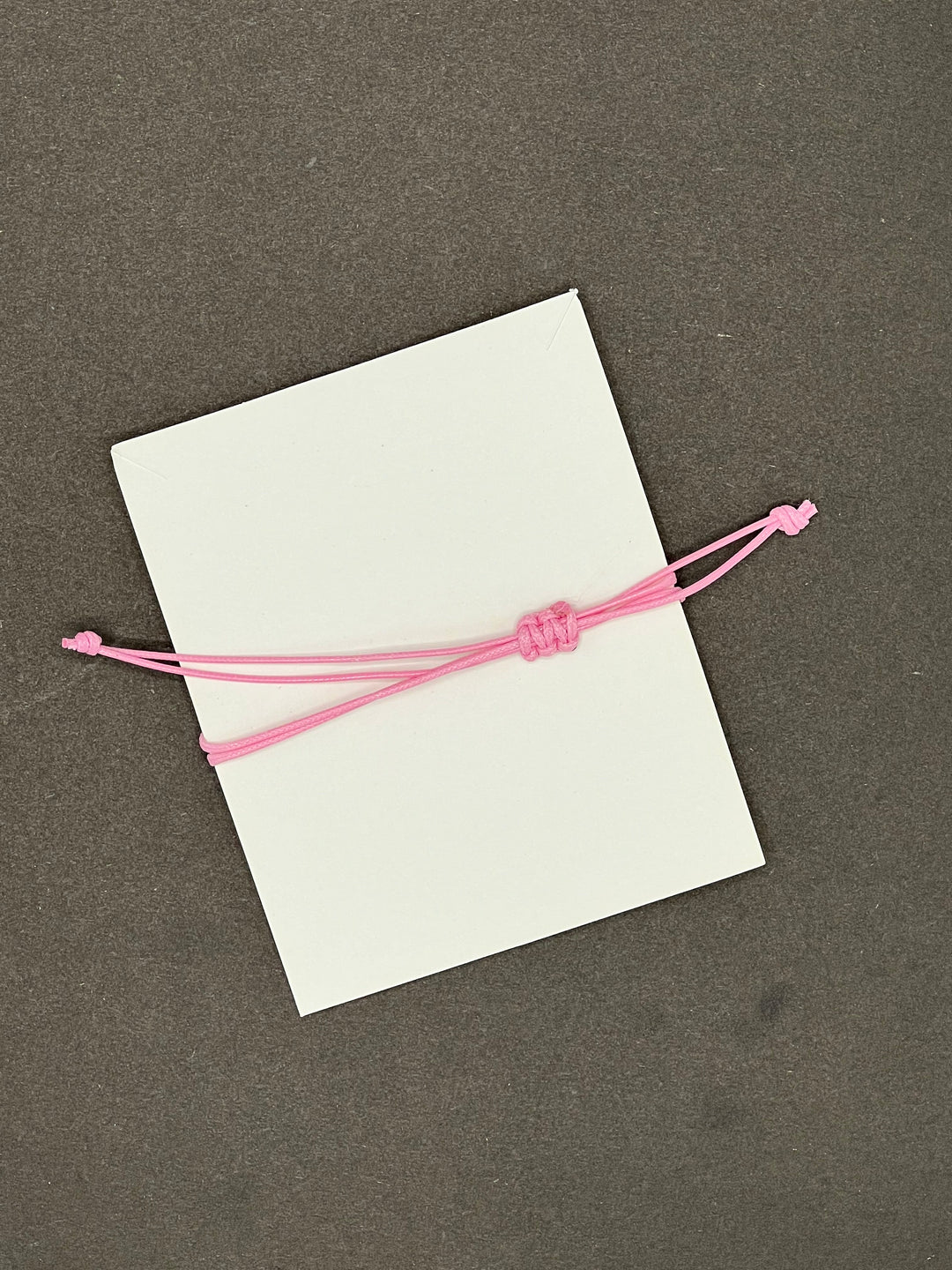 HOPE,FAITH,LOVE RING SHAPED CHARM BRACLETE WITH SLIDER KNOT ON BABY PINK STRING