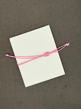 HOPE,FAITH,LOVE RING SHAPED CHARM BRACLETE WITH SLIDER KNOT ON BABY PINK STRING